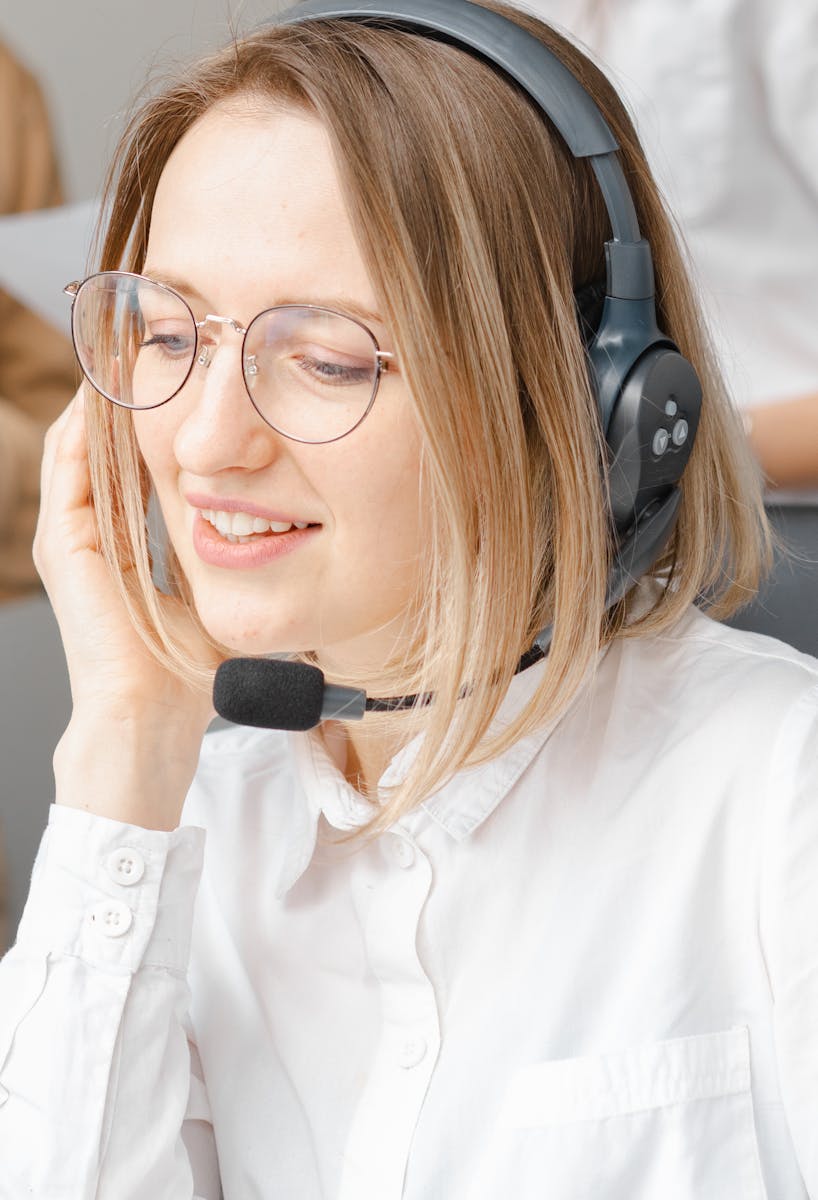 Customer support agent providing service with a smile, using headset.